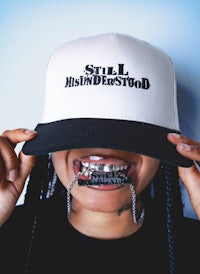 a woman wearing a hat with the word soul hollywood on it