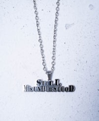 a silver necklace with the word'stupid'on it