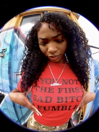 a woman wearing a t-shirt that says you are not the first bad bitch slumber