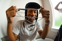 a man is holding a chain in his mouth
