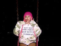 a woman sitting on a swing at night